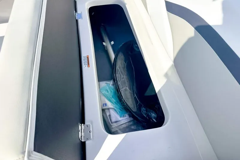 Slide: The Image of Storage compartment in 2024 Starcraft SVX 211 OB boat, featuring various items inside. - 8