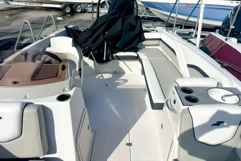 Slide: The Image of 2024 Starcraft SVX 211 OB boat interior with seating and steering console. - 9