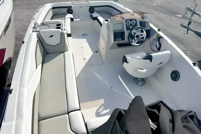 Slide: The Image of 2024 Starcraft SVX 211 OB boat interior with seating and steering console. - 3