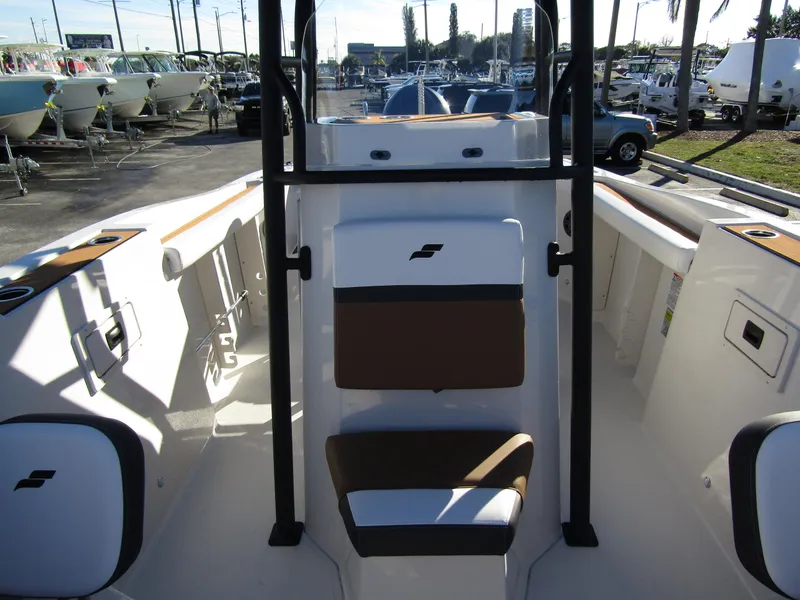 Slide: The Image of 2024 Starcraft SVX 231 OB CC boat interior with seating and storage compartments. - 13