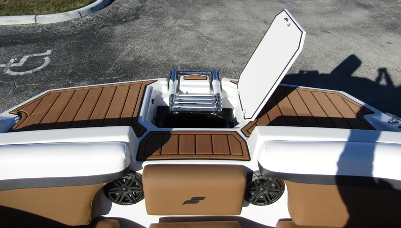 Slide: The Image of 2024 Starcraft SVX 231 OB CC boat with open storage compartment. - 8