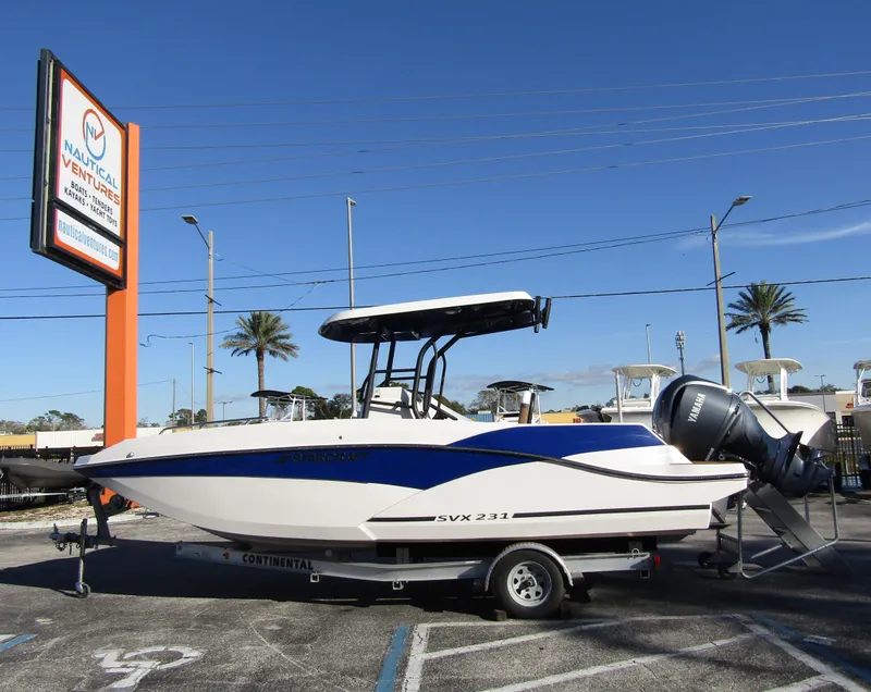 The Image of 2024 Starcraft SVX 231 OB CC boat on trailer at dealership. - 0
