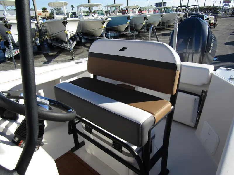 Slide: The Image of 2024 Starcraft SVX 231 OB CC boat interior with seating and steering wheel. - 17