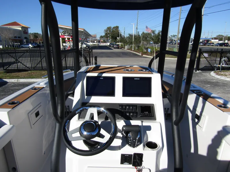 Slide: The Image of 2024 Starcraft SVX 231 OB CC boat console with dual screens and steering wheel. - 18