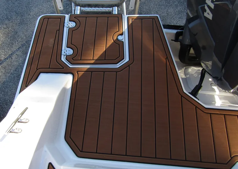 Slide: The Image of 2024 Starcraft SVX 231 OB CC boat deck with brown marine flooring. - 30