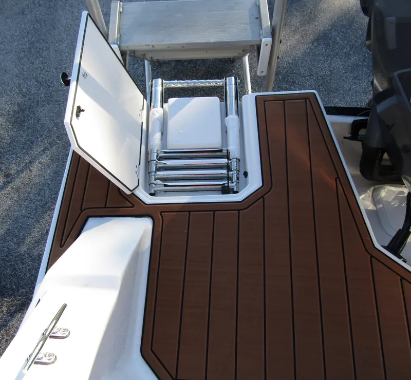 Slide: The Image of 2024 Starcraft SVX 231 OB CC boat with open hatch and retractable ladder. - 31