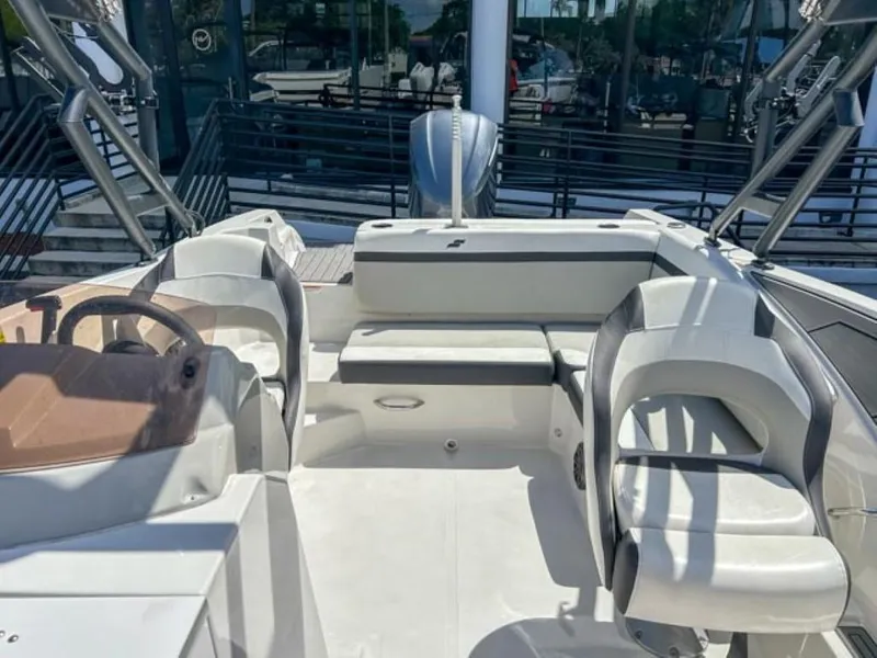 Slide: The Image of 2024 Starcraft SVX 231 OB DH boat interior with seating and steering wheel. - 6