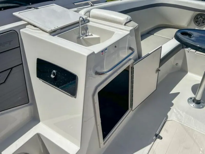 Slide: The Image of 2024 Starcraft SVX 231 OB DH boat interior with sink and storage compartments. - 10