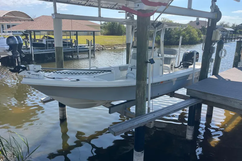 The Image of 2022 KenCraft 239 Bay Rider boat docked on a lift by the water. - 1