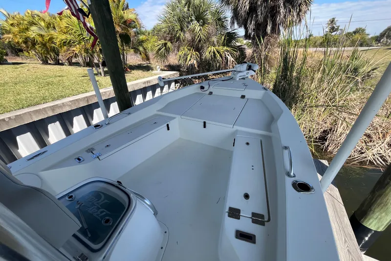 Slide: The Image of 2022 KenCraft 239 Bay Rider boat docked near lush greenery. - 11