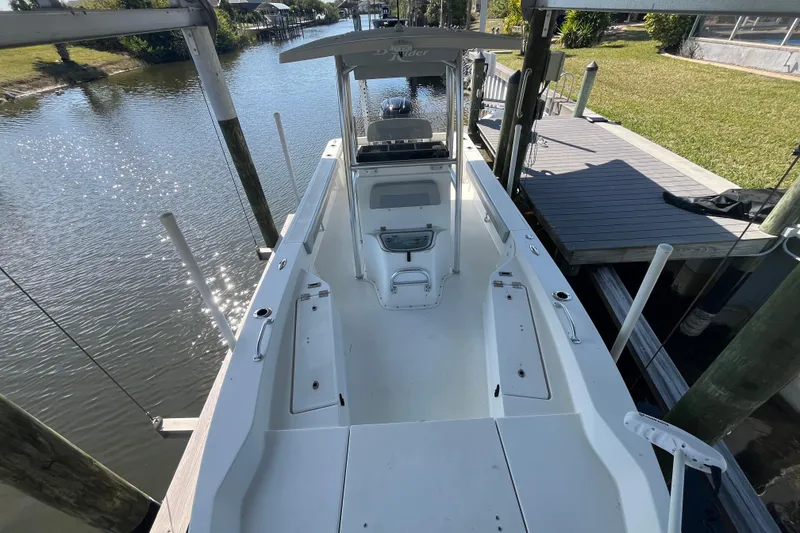 Slide: The Image of 2022 KenCraft 239 Bay Rider boat docked on a sunny waterfront. - 14