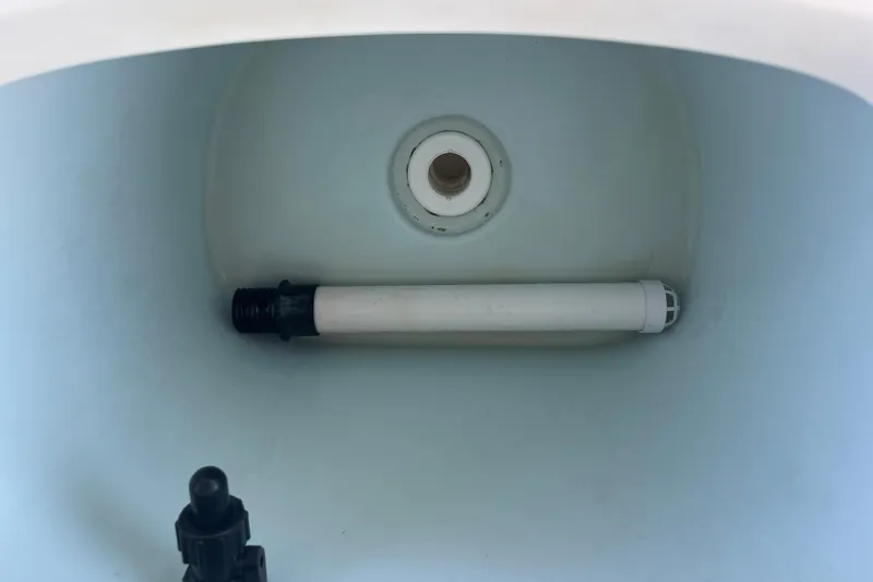 Slide: The Image of Livewell interior of 2022 KenCraft 239 Bay Rider boat, featuring a drain and pipe. - 18