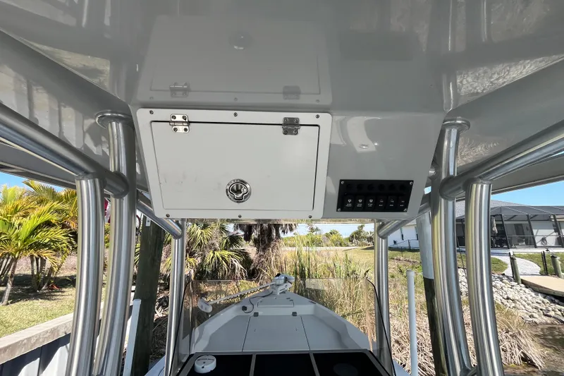 Slide: The Image of 2022 KenCraft 239 Bay Rider boat console with storage and control panel. - 19