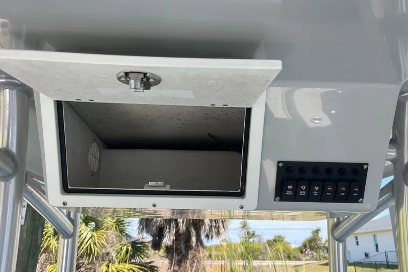 Slide: The Image of 2022 KenCraft 239 Bay Rider console storage and control panel with switches. - 20