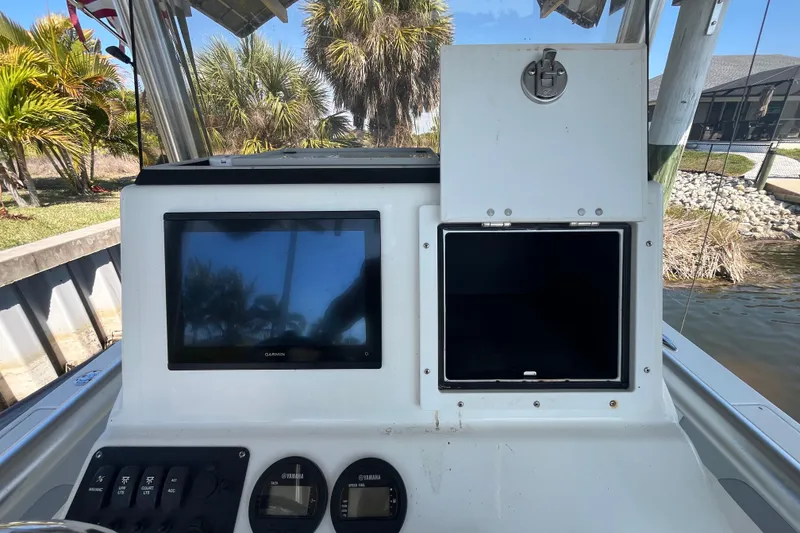 Slide: The Image of 2022 KenCraft 239 Bay Rider console with Garmin display and control panel. - 21