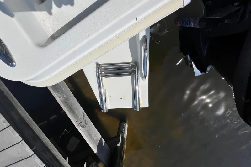 Slide: The Image of 2022 KenCraft 239 Bay Rider boat ladder and platform by the water. - 22