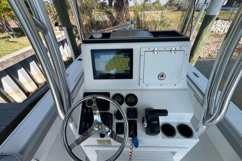 Slide: The Image of 2022 KenCraft 239 Bay Rider boat console with navigation screen and controls. - 24