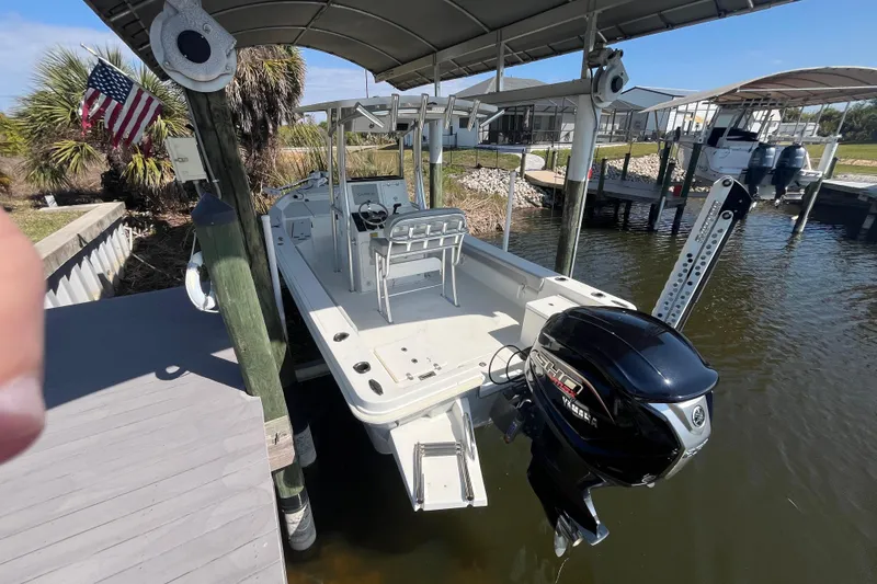 Slide: The Image of 2022 KenCraft 239 Bay Rider boat docked with Yamaha outboard motor, under canopy. - 3