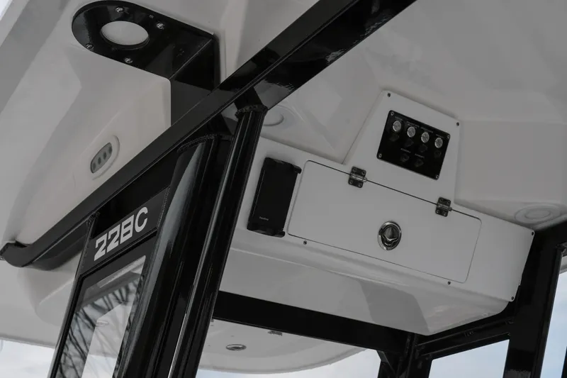 Slide: The Image of 2026 Sea Fox 228 Commander boat interior with control panel and storage compartment. - 14