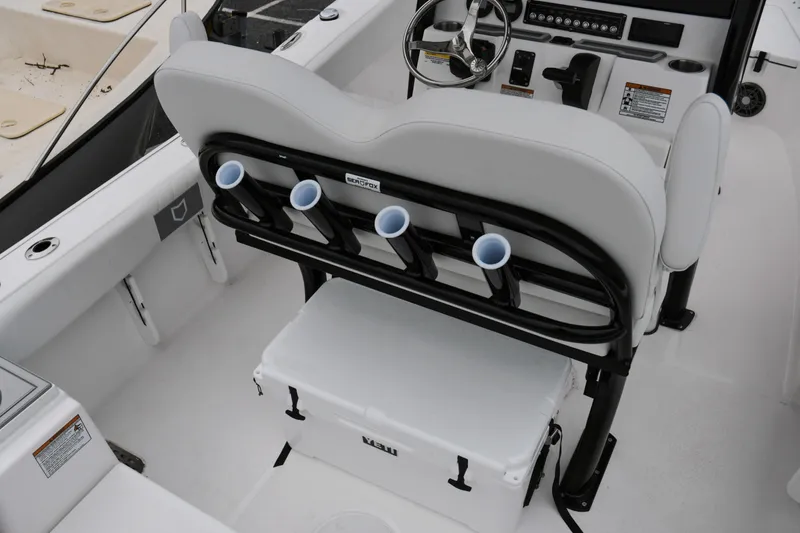 Slide: The Image of 2026 Sea Fox 228 Commander boat interior with rod holders and cooler. - 15