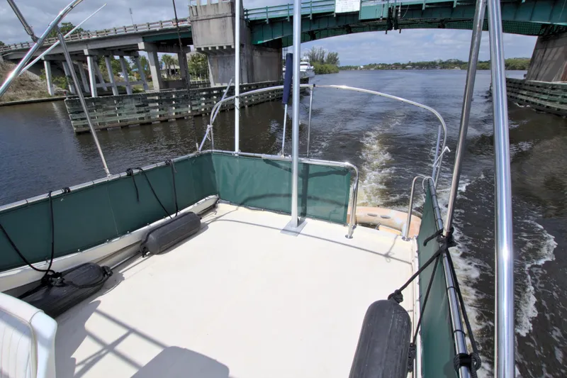 Slide: The Image of 2004 Camano 31 Troll boat cruising under a bridge on a sunny day. - 10