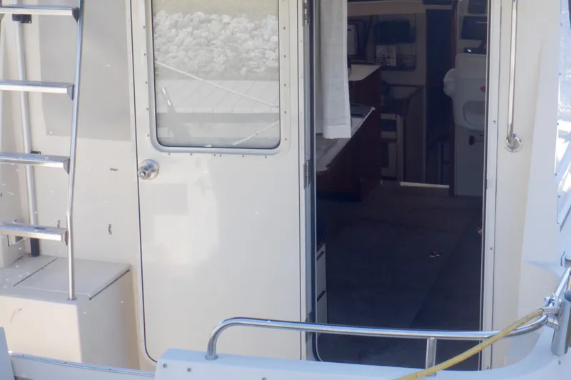 Slide: The Image of 2004 Camano 31 Troll boat interior view with open door and ladder. - 14