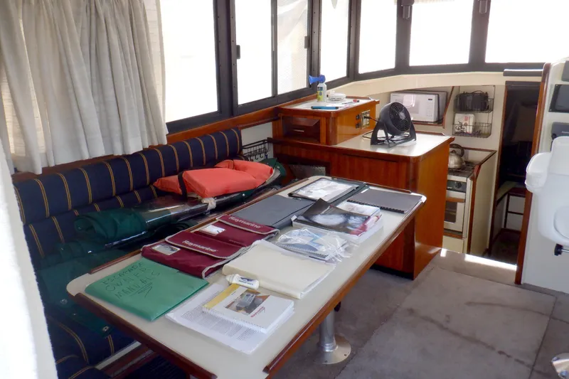 Slide: The Image of Interior of 2004 Camano 31 Troll boat with table, seating, and navigation equipment. - 16