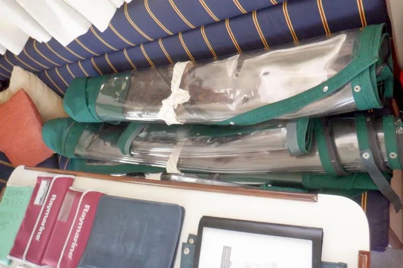 Slide: The Image of Stored equipment and manuals on a 2004 Camano 31 Troll boat interior. - 18