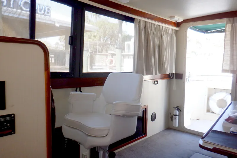 Slide: The Image of Interior of 2004 Camano 31 Troll boat with white captain's chair and large windows. - 19