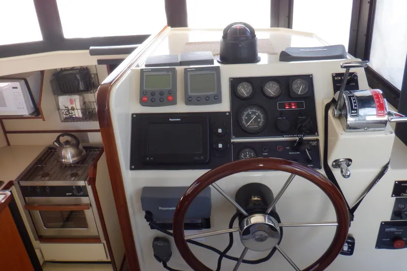 Slide: The Image of 2004 Camano 31 Troll helm with navigation instruments and kitchen area. - 20