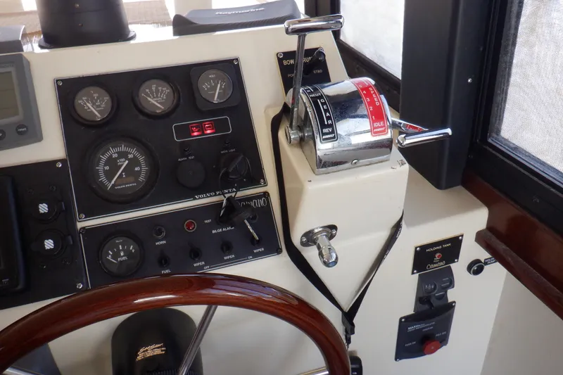 Slide: The Image of Control panel of a 2004 Camano 31 Troll boat with gauges and throttle. - 21