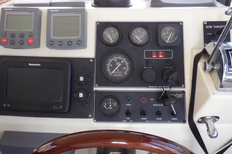 Slide: The Image of 2004 Camano 31 Troll dashboard with Raymarine instruments and Volvo Penta controls. - 22