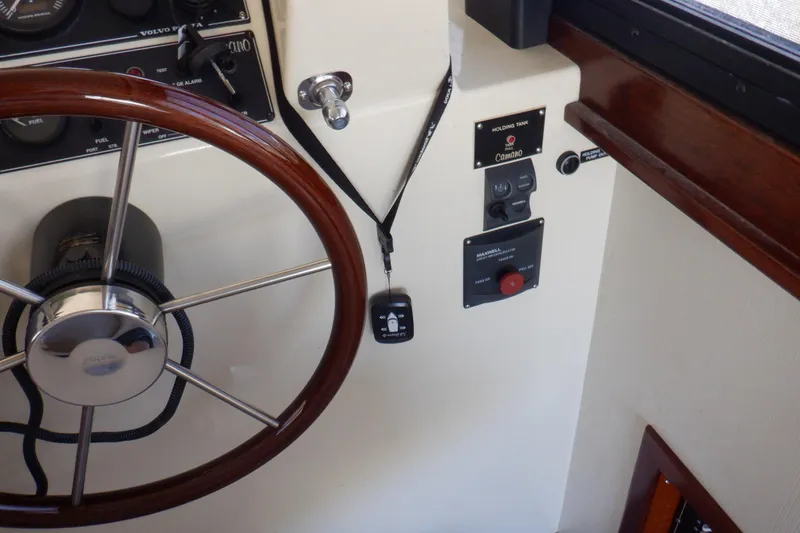 Slide: The Image of Steering wheel and controls of 2004 Camano 31 Troll boat cockpit. - 26