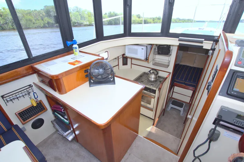 Slide: The Image of 2004 Camano 31 Troll boat interior with kitchenette, microwave, and cozy sleeping area. - 27