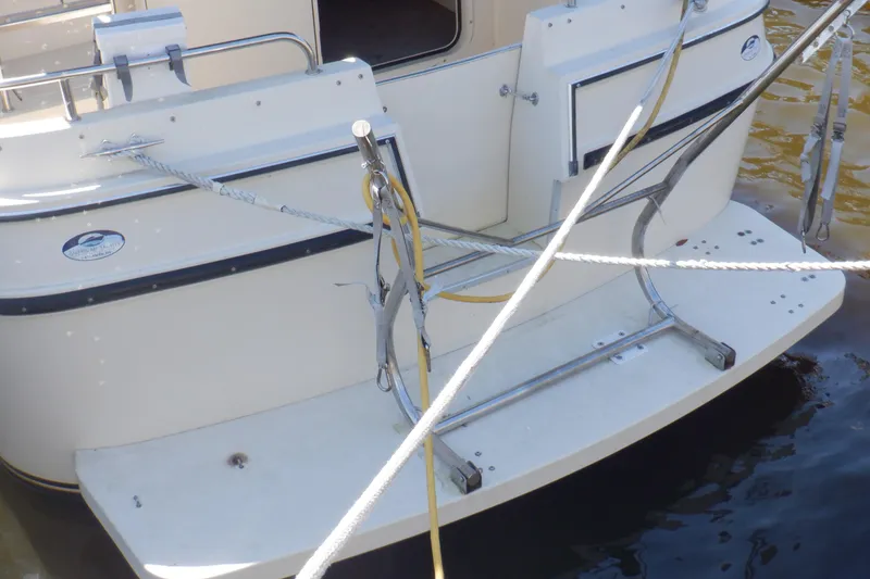 Slide: The Image of 2004 Camano 31 Troll boat stern with ropes and swim platform. - 3