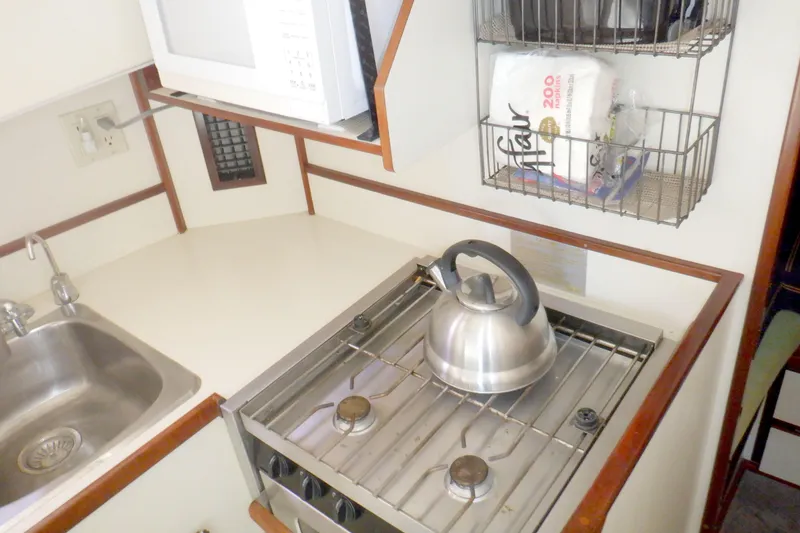 Slide: The Image of Compact kitchen in 2004 Camano 31 Troll boat with stove, sink, and microwave. - 30