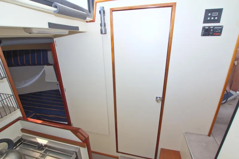 Slide: The Image of Interior of 2004 Camano 31 Troll boat, featuring compact kitchen and cozy sleeping area. - 31