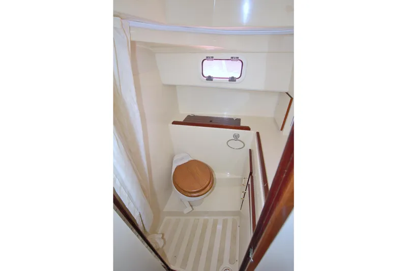 Slide: The Image of Compact bathroom in 2004 Camano 31 Troll boat with wooden toilet seat and small window. - 32
