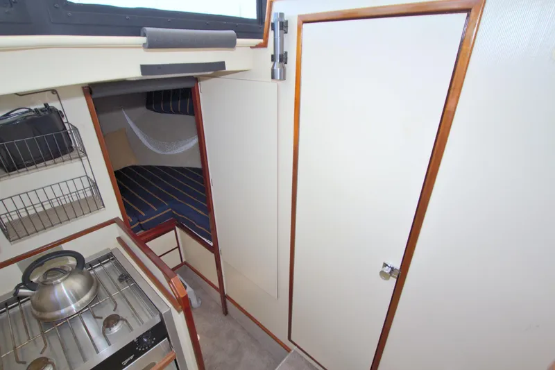 Slide: The Image of Interior of 2004 Camano 31 Troll boat with compact kitchen and cozy sleeping area. - 34