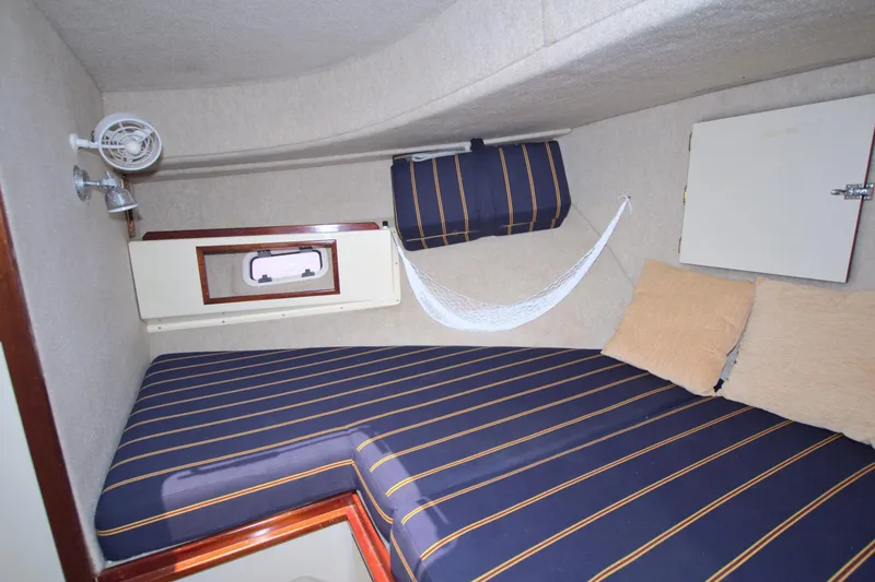 Slide: The Image of Cozy cabin interior of 2004 Camano 31 Troll with striped bedding and small fan. - 38