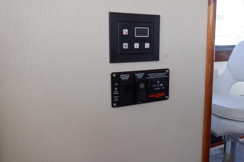 Slide: The Image of Control panel inside 2004 Camano 31 Troll boat, featuring generator and system controls. - 39