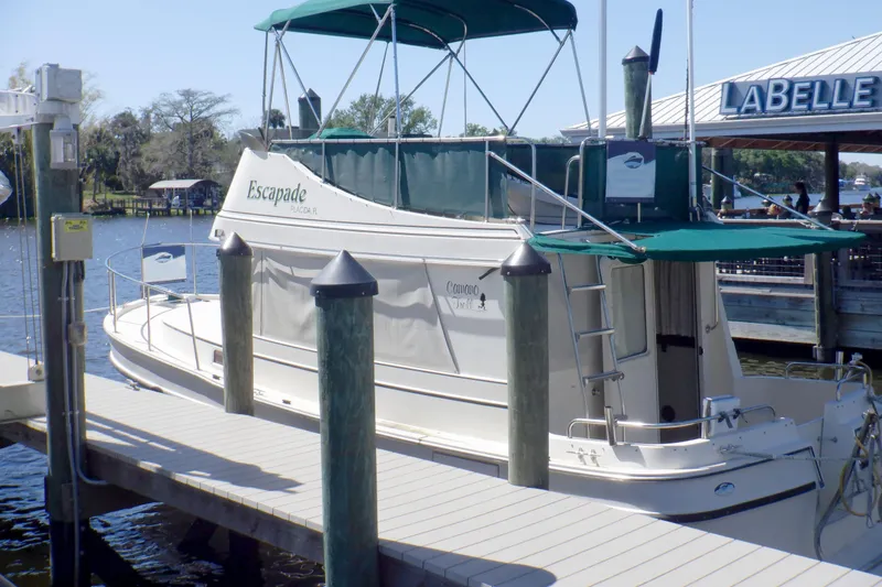 Slide: The Image of 2004 Camano 31 Troll boat docked at marina with green canopy. - 4