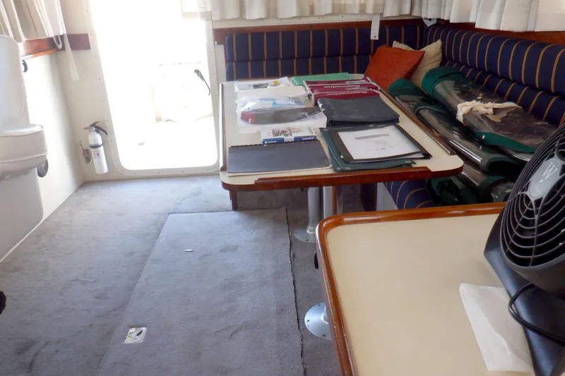 Slide: The Image of Interior of 2004 Camano 31 Troll boat with table, documents, and seating area. - 40