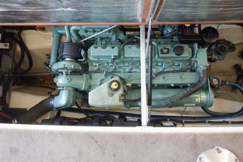 Slide: The Image of Engine compartment of a 2004 Camano 31 Troll boat, featuring a Volvo engine. - 42