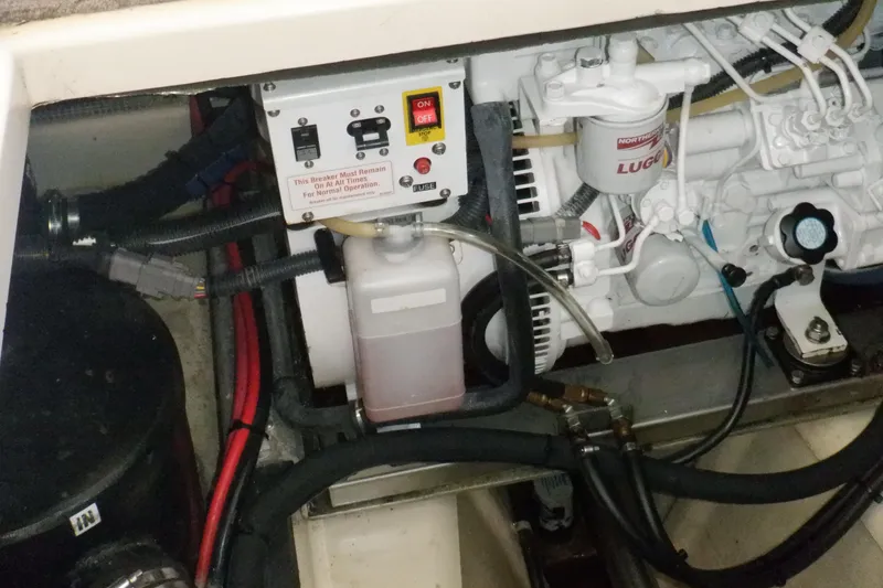 Slide: The Image of Engine compartment of a 2004 Camano 31 Troll boat, featuring control panel and wiring. - 44