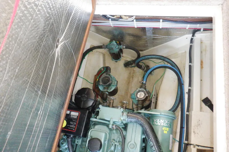 Slide: The Image of Engine compartment of a 2004 Camano 31 Troll boat, featuring Volvo Penta components. - 47