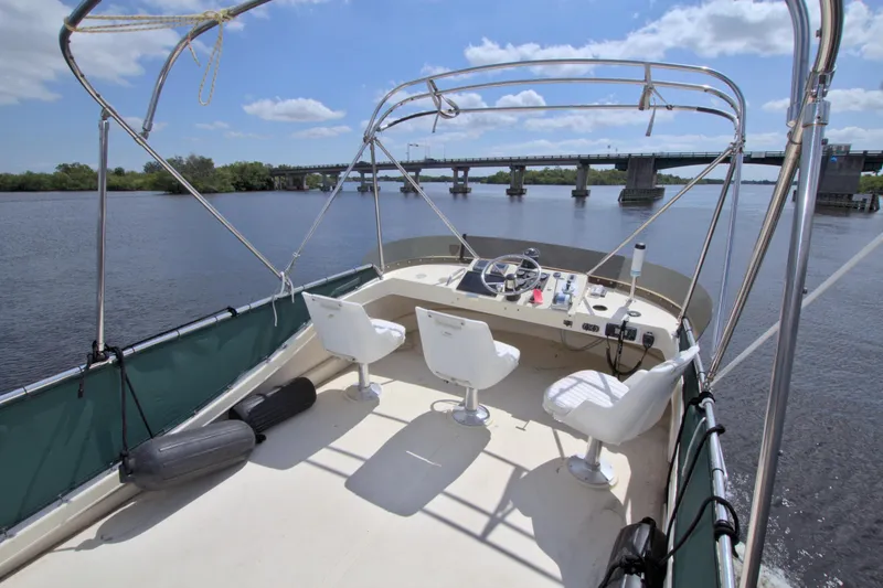 Slide: The Image of 2004 Camano 31 Troll boat deck with helm, chairs, and river view. - 8
