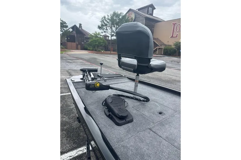 Slide: The Image of 2026 Tracker Pro 170 boat deck with seat and trolling motor in parking lot. - 63
