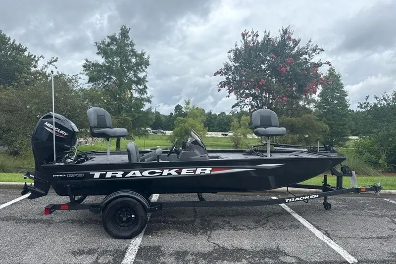 The Image of 2026 Tracker Pro 170 boat on trailer, parked outdoors with trees in background. - 0
