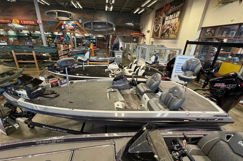Slide: The Image of A 2026 Ranger Z519R boat in a showroom. It features gray seating and modern equipment. - 2